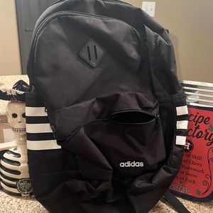 Adidas backpack black and white with stripes.